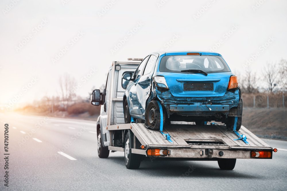 Towing Truck With A Damaged Vehicle After Car Accident Collision