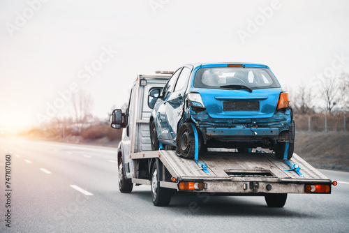 Towing Truck With A Damaged Vehicle After Car Accident Collision