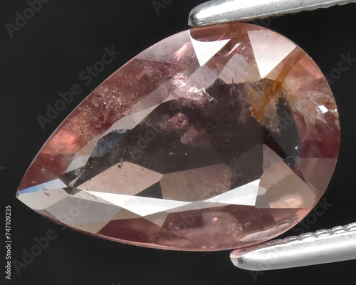 natural peach sapphire gem on the background photo