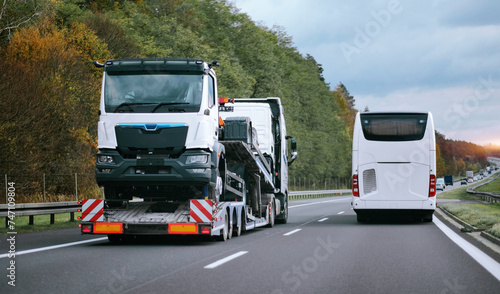 Towing truck with a brand-new commercial vehicle for cargo shipping. Emergency roadside assistance. Vehicle Mechanical Problem on the Road. Warranty case. Bill of Loading Manifest. 