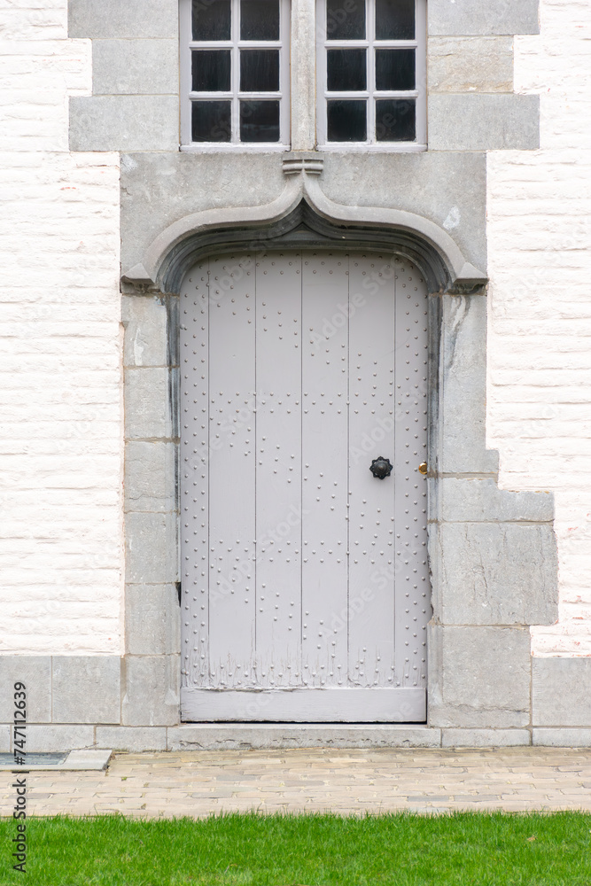 Fototapeta premium old wooden door with wall,Gray wooden door against the background of a gray brick wall, rustic doors