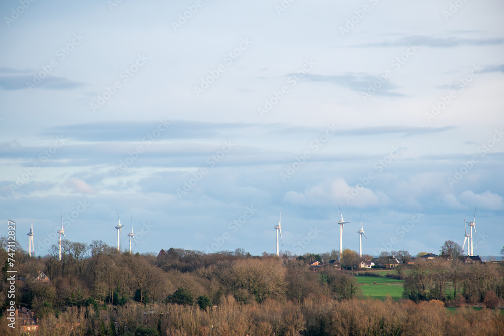 wind turbine in the countryside,Autumn landscape with windmills in the background, windmills for generating electricity integrated into the natural landscape 