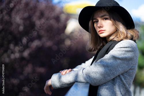 Portrait of a young girl in a black hat