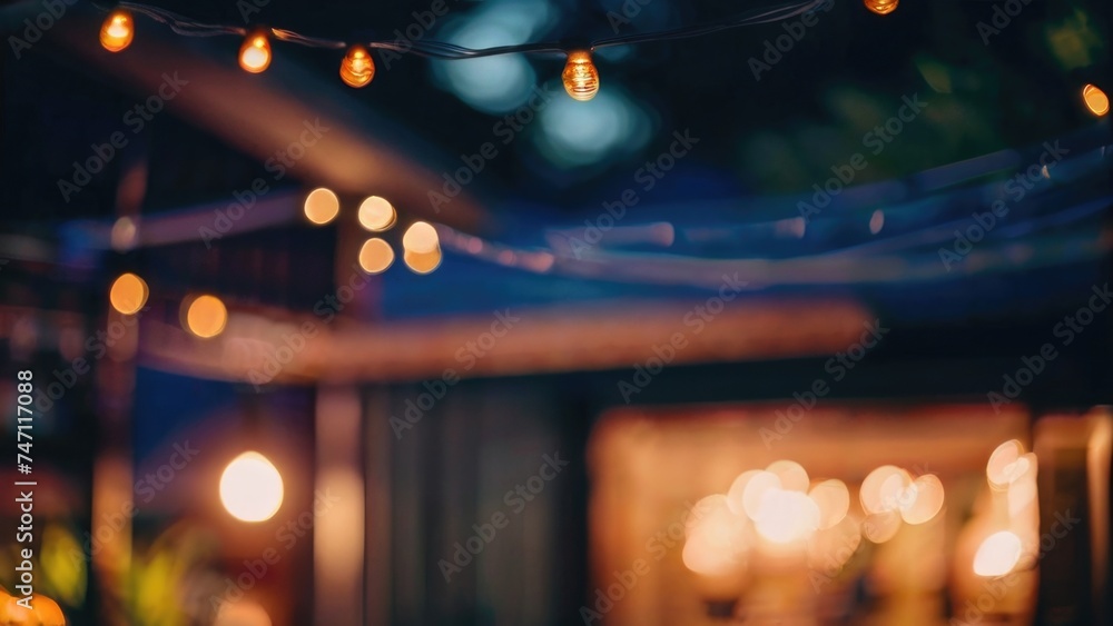 Defocused restaurant with outdoor string lights on a blurred background Defocused restaurant with outdoor string lights on a blurred background