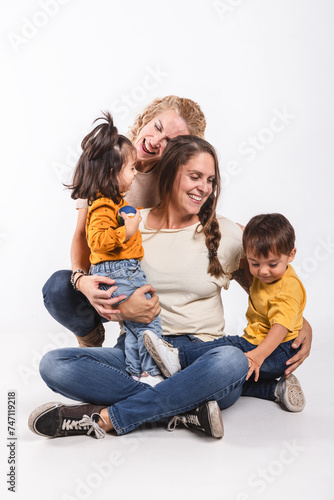 Portrait of a homosexual couple with their children on white background