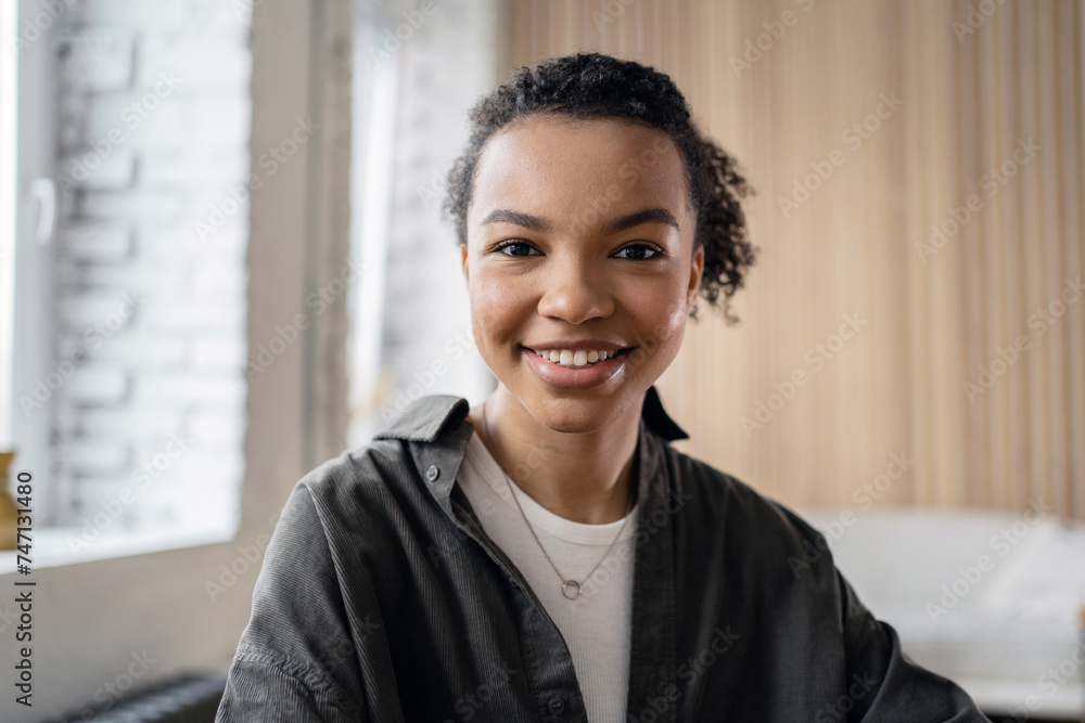 Confident young woman with a bright smile indoors. Confident young woman with a bright smile indoors.