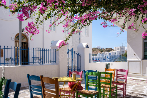 View of a bar restaurant with a picturesque terrace outdoors and colorful chairs in Ios cyclades Greece photo