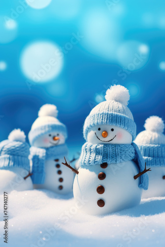 Group of snowmen standing in snowy landscape, suitable for winter themes © Luisa