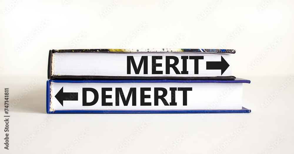Demerit or merit symbol. Concept word Demerit or Merit on beautiful books. Beautiful white table white background. Business and demerit or merit concept. Copy space.
