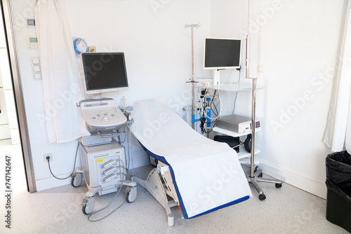 A white and sterile medical room with advanced ultrasound technology.