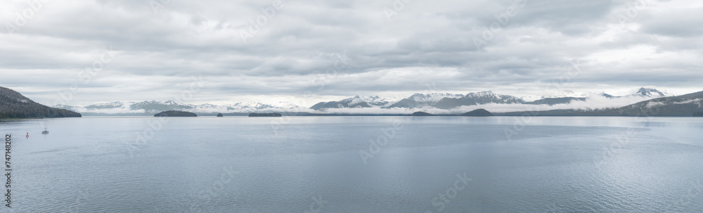 Panorama of clouds and mist around the snow covered mountains of Frederick Sound in Alaska, USA