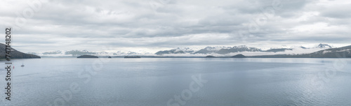 Panorama of clouds and mist around the snow covered mountains of Frederick Sound in Alaska, USA © dvlcom