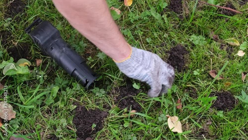 Hands of gardener setting a mole trap, close-up video photo