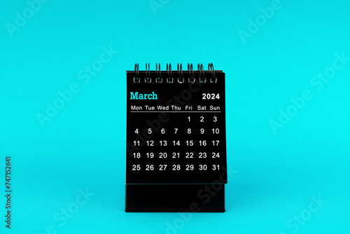 Black Calendar for March 2024. Desktop calendar on a green background.