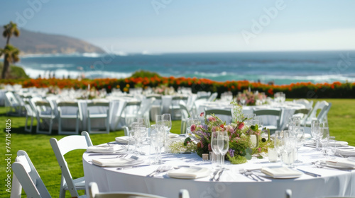 Background A breezy outdoor banquet with white linencovered tables and a view of the rolling waves.