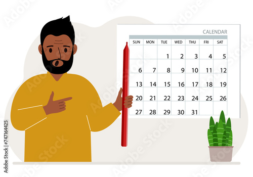 A man with a pencil in his hand creates a calendar. Planning and time management, responsible employee plans meetings and events.