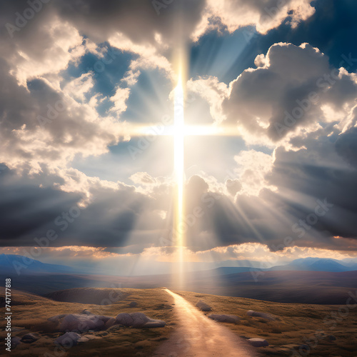 The sky is cloudy, with a dramatic appearance and light rays shining through. In the middle of the scene, there is a backlit holy cross