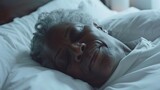 A serene elderly woman with gray hair peacefully sleeping with a gentle smile on her face nestled comfortably in a soft white bed.