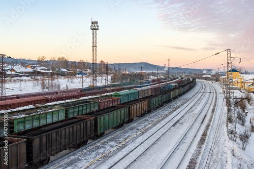 Delivery of goods by rail. Top view of freight railway cars. Freight trains with coal and cargo. Transport infrastructure and cargo transportation. Baikal-Amur Mainline (BAM), Eastern Siberia, Russia.