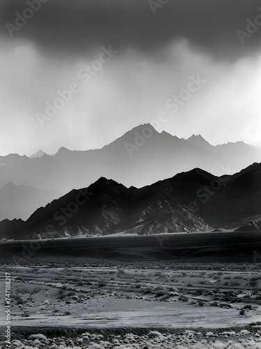 dark ominous mountain tops with clouds and rain falling from above  black sand beaches in the foreground  icelandic landscape