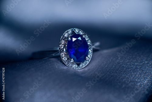 Golden ring with blue gemstone, sapphire