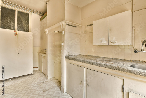 Old neglected kitchen interior with vintage appliances photo