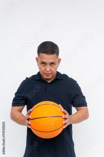 Intense middle aged man gripping a basketball, looking determined. Perfect for sports and fitness concepts. Isolated on white. © Mdv Edwards