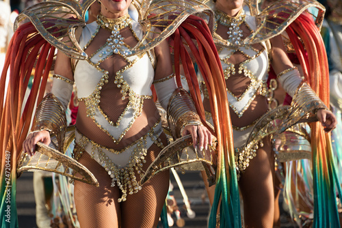 Beautiful bright colorful carnival costume. Two samba dancers hips carnival costume bikini feathers rhinestones close up