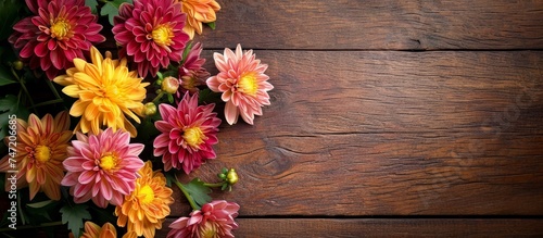 An arrangement of colorful flowers is displayed on a rustic wooden table, creating a vibrant and natural centerpiece.