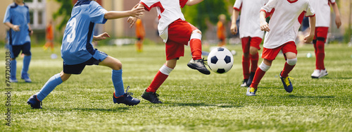 Soccer Youth Teams Play Outdoor Tournament. Young Soccer Players Competition. Boys Kicking Football Ball. Soccer Stadium in the Background