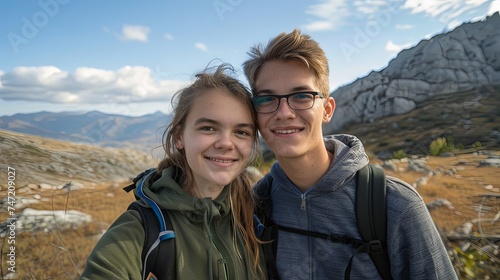 Man and woman couple taking selfie on mountain together