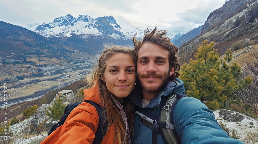 Man and woman couple taking selfie on mountain together