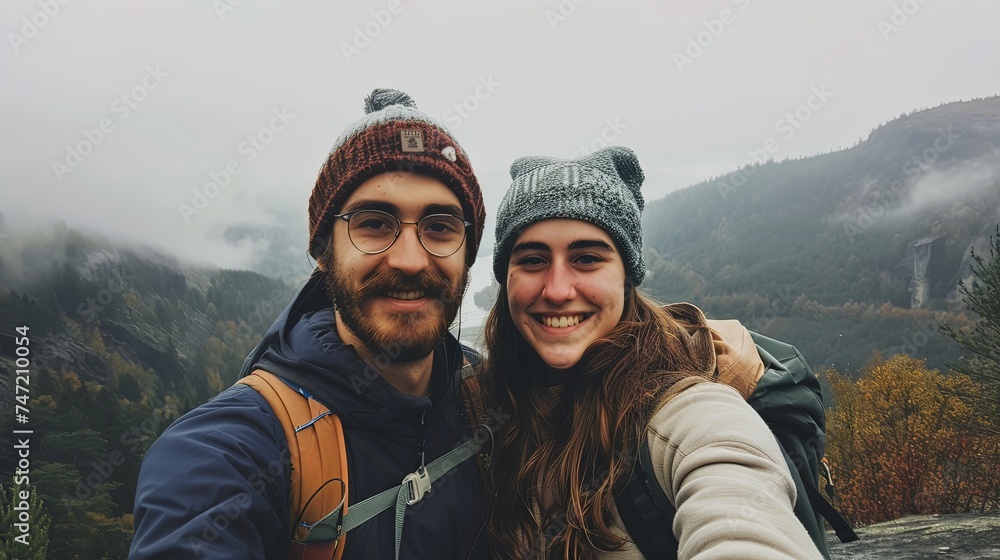 Man and woman couple taking selfie on mountain together