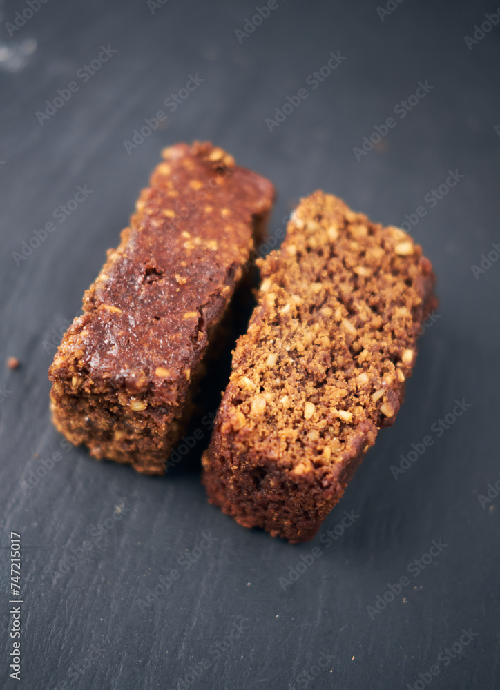 A beautiful chocolate flapjack dessert slice, served on a rustic slate plate board. Gourmet and posh trendy cafe and bakery treat. Sugar sweeties. A beautiful chocolate flapjack dessert slice, served on a rustic slate plate board. Gourmet and posh trendy cafe and bakery treat. Sugar sweeties.
