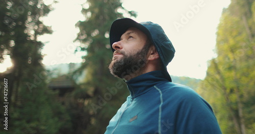 Male traveler, portrait close-up. Travel, hiking and camping concept happy man with cup camping in the forest.