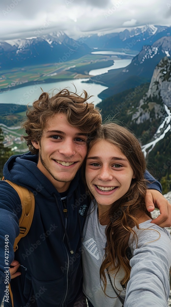 Vertical portrait of young couple on a mountain smiling