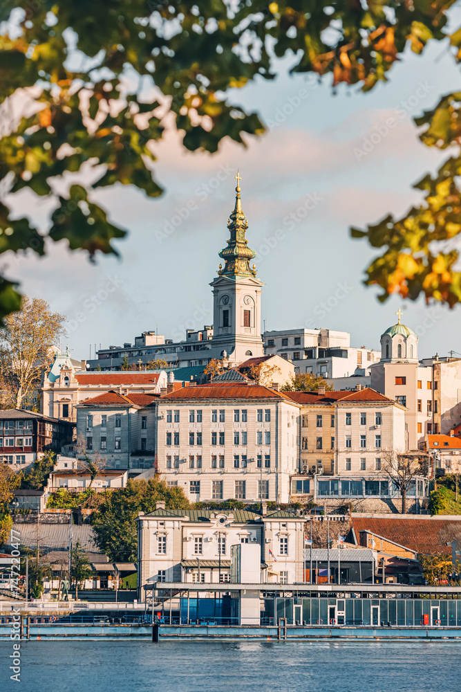 Serene river views complement Belgrade's architectural charm, with churches adorning the skyline under sunny skies.