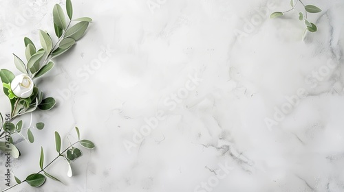 Delicate white flowers and green foliage arranged on a marbled surface give a luxurious, serene vibe