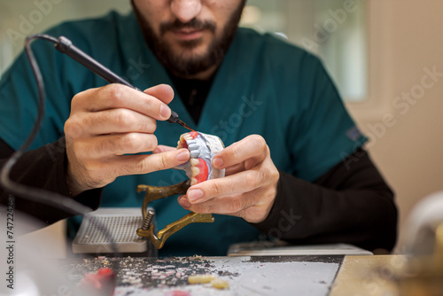 Close up of Dental Technician Molds a Dental Crown in Wax