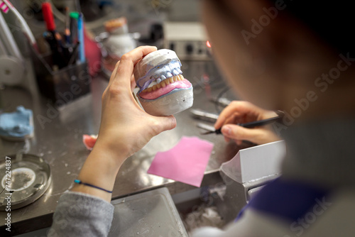 Dental technician makes a denture for the patient. Prosthetics and Production of Model Teeth in Dentistry