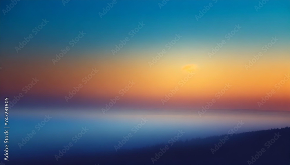 Abstract misty blurry landscape background image with sunrise gradient hues, blue and orange tones over the clouds