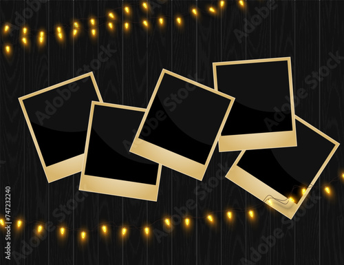 Vintage photo frames polaroids with garlands on a wooden background
