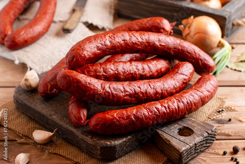 Smoked sausage on a wooden table, natural product from organic farm