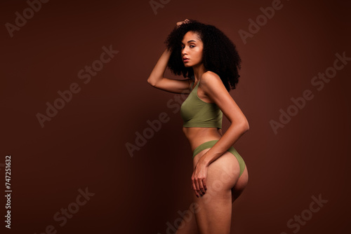 No filter studio photo of dreamy tempting woman wear lingerie enjoying body positive empty space isolated brown color background