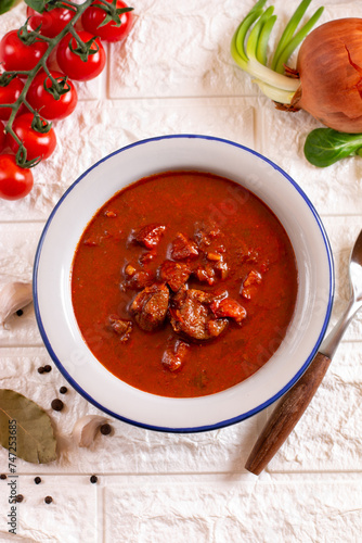 Goulash soup with beef and sweet pepper. Stew of meat and vegetables, flavored with paprika. Hungarian cuisine. photo