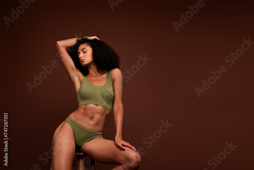 Photo of stunning perfect girl wear khaki activewear strong body sexual shape no retouch empty space isolated over brown color background