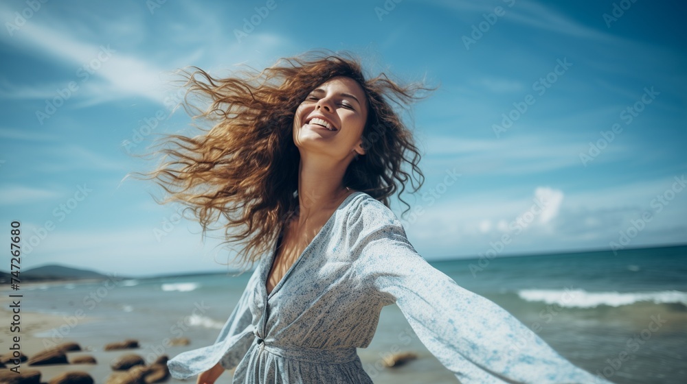 Capture a beautiful portrait of a young woman at the beach with arms wide open, relishing in free time and the liberating feeling of freedom outdoors. Capture a beautiful portrait of a young woman at the beach with arms wide open, relishing in free time and the liberating feeling of freedom outdoors.
