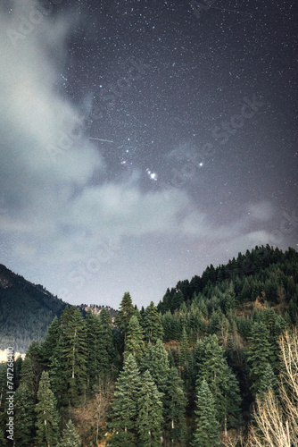 Orion constellation rising above the mountains