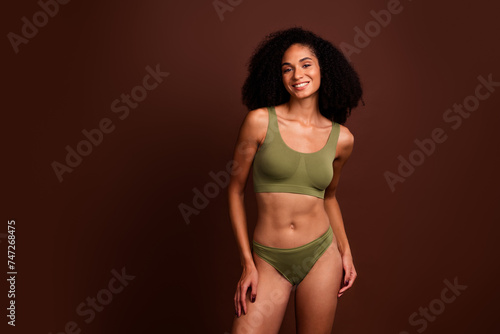 No filter studio photo of shiny lovely woman wear lingerie enjoying self acceptance empty space isolated brown color background © deagreez