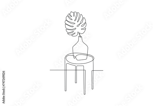 Continuous one line drawing of table with plant vector illustration.